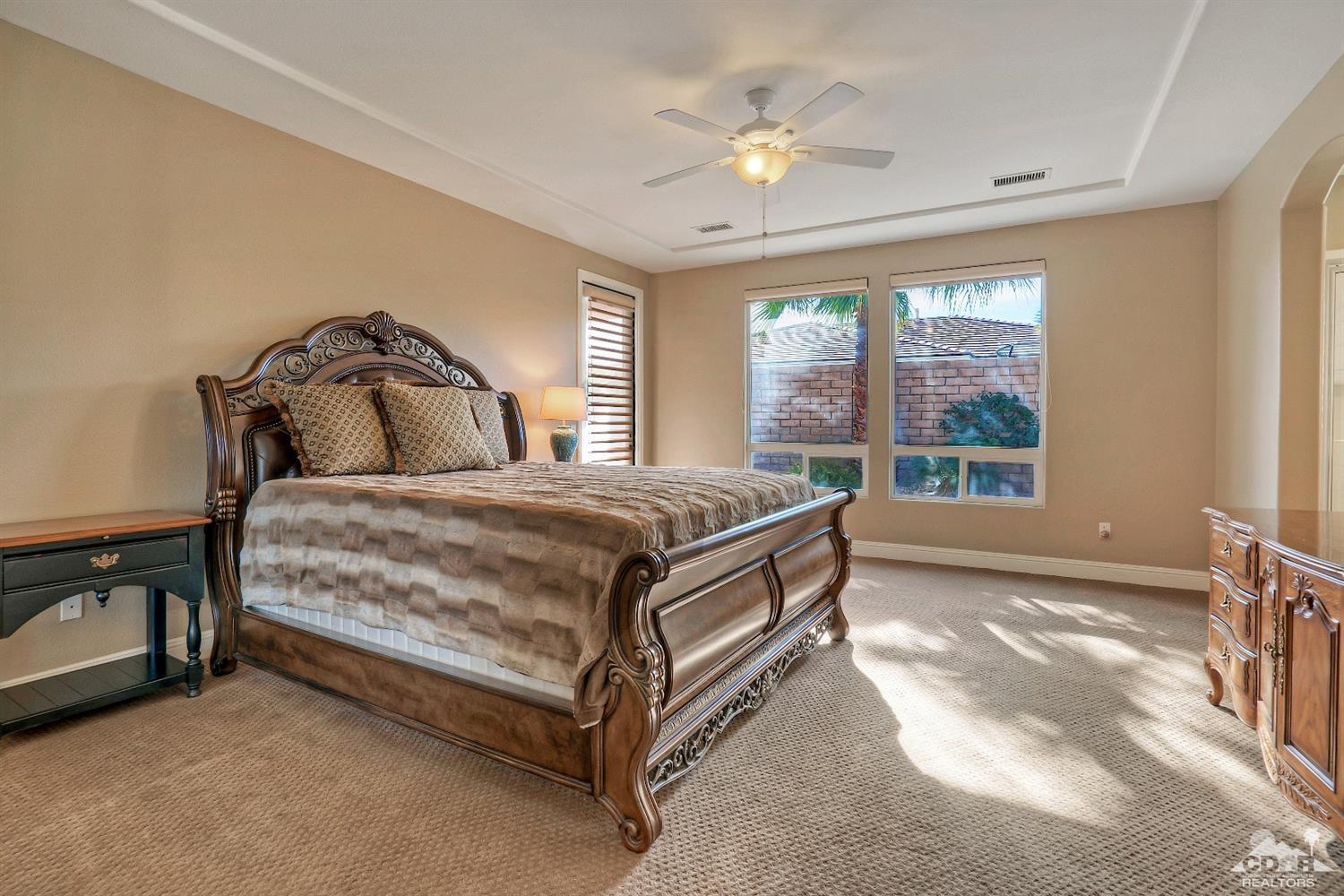 186 Via Milano Rancho Mirage, CA 92270 - Photo 14 of 24 a spacious bedroom with a bed and a window