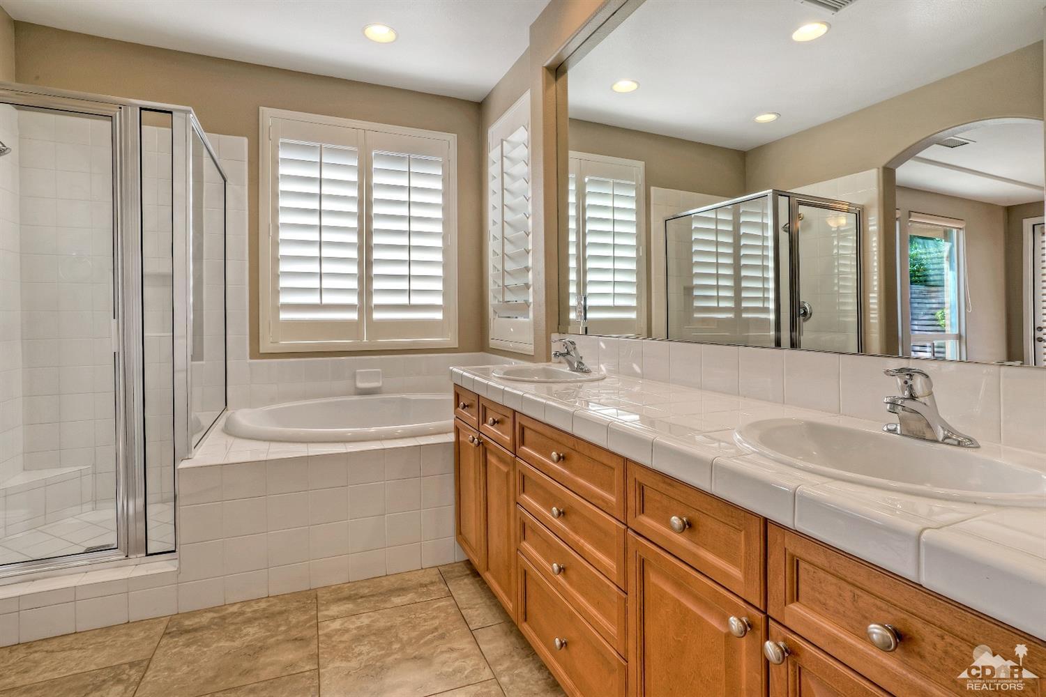 186 Via Milano Rancho Mirage, CA 92270 - Photo 15 of 24 a bath room with a sink and a large mirror