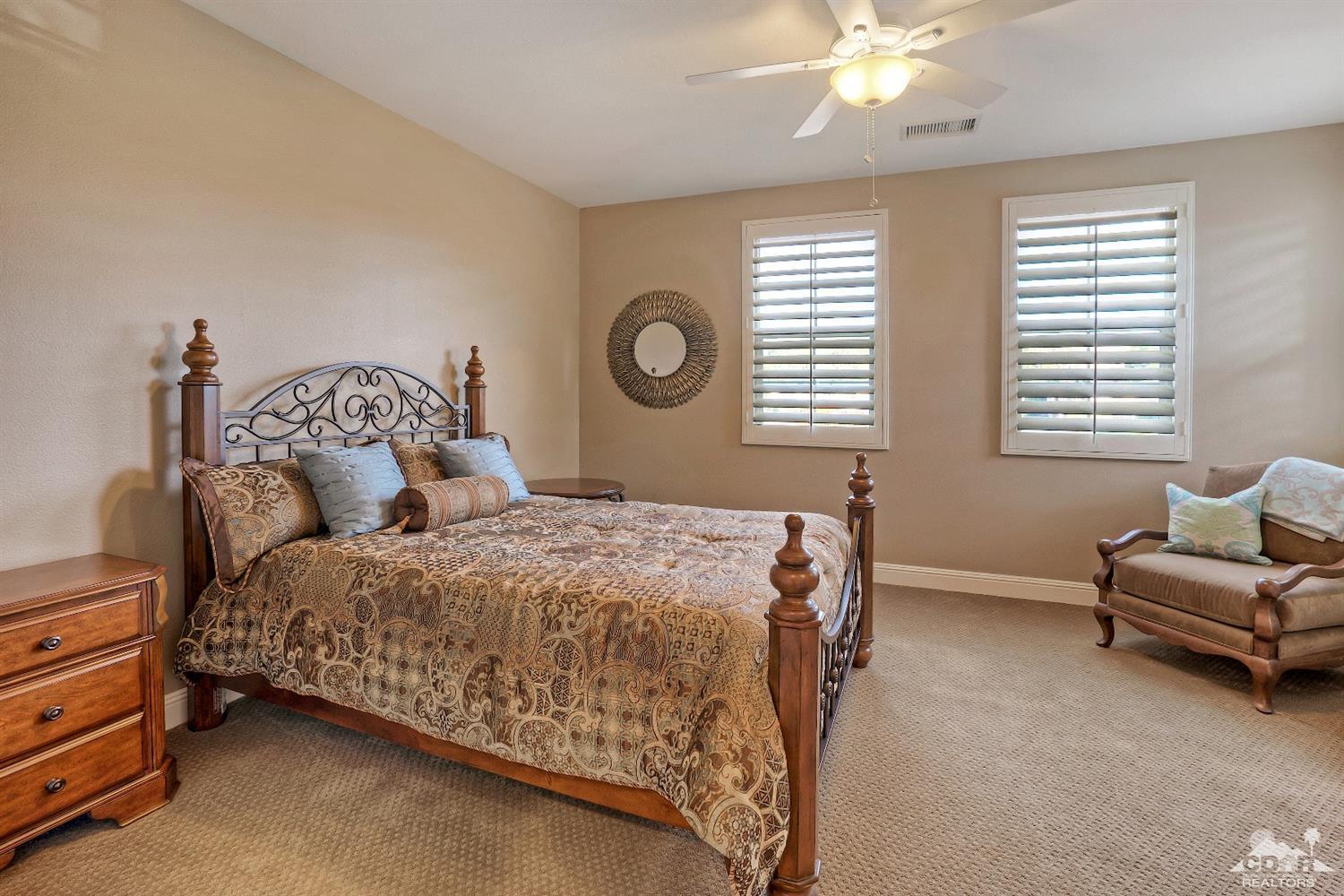 186 Via Milano Rancho Mirage, CA 92270 - Photo 16 of 24 a bed room with a bed and a chair