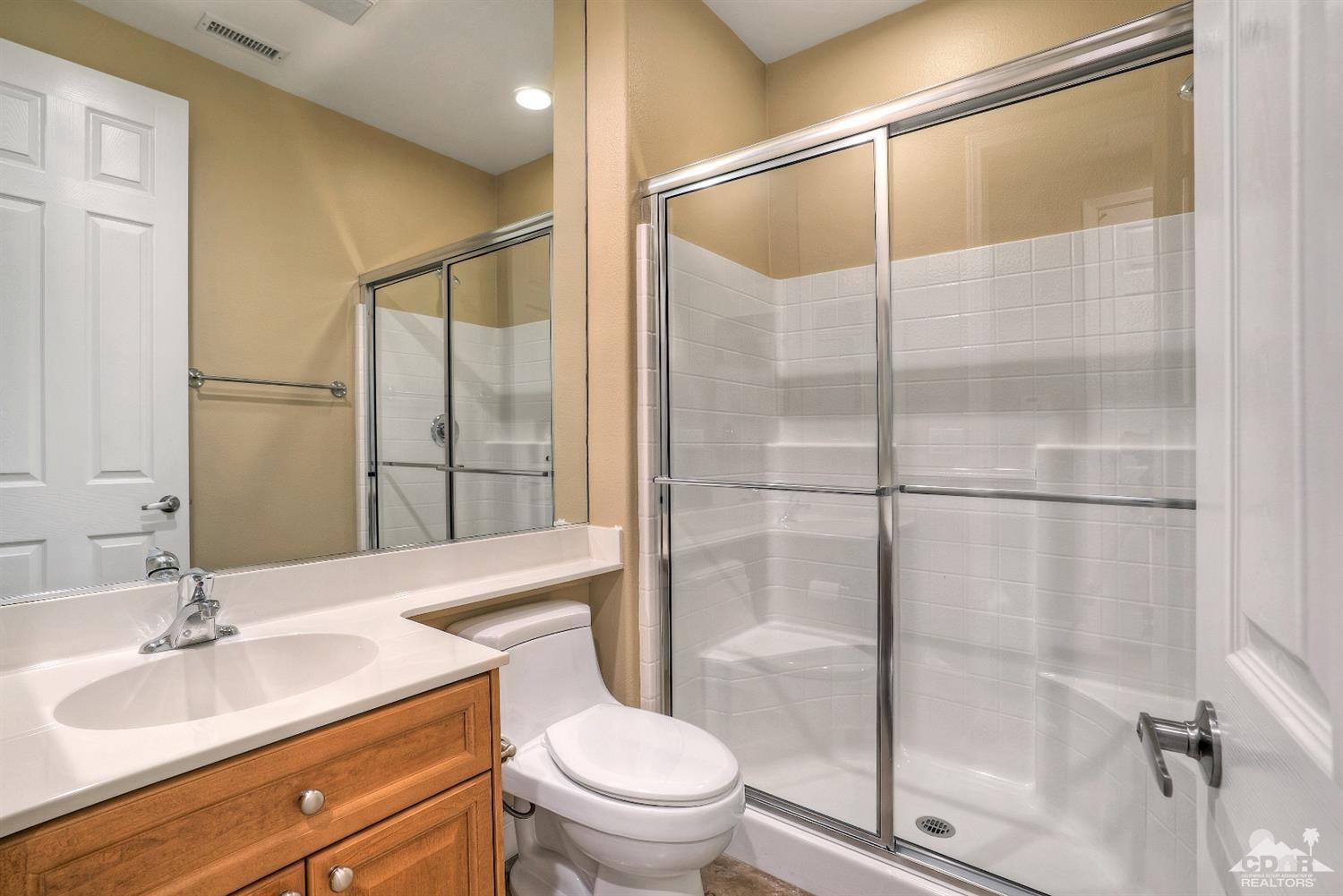 186 Via Milano Rancho Mirage, CA 92270 - Photo 17 of 24 a bathroom with a granite countertop sink toilet and shower