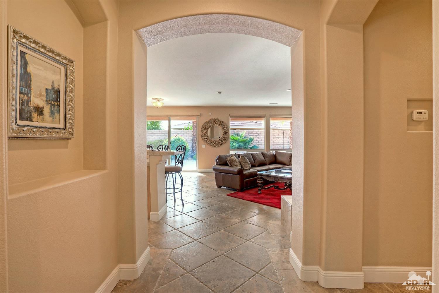 186 Via Milano Rancho Mirage, CA 92270 - Photo 5 of 24 a living room with furniture and a mirror