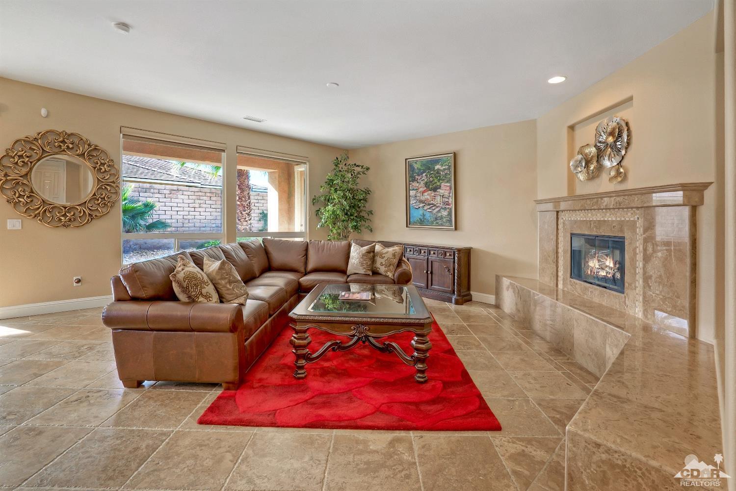 186 Via Milano Rancho Mirage, CA 92270 - Photo 6 of 24 a living room with furniture and a fireplace