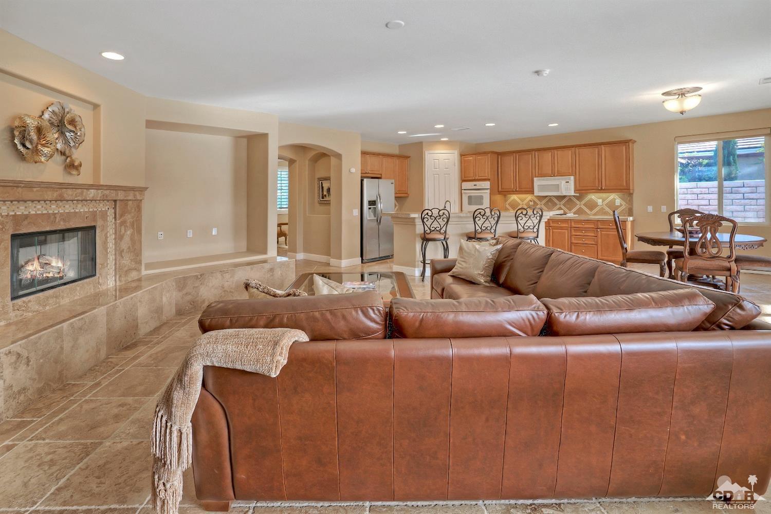 186 Via Milano Rancho Mirage, CA 92270 - Photo 8 of 24 a living room with furniture and a fireplace