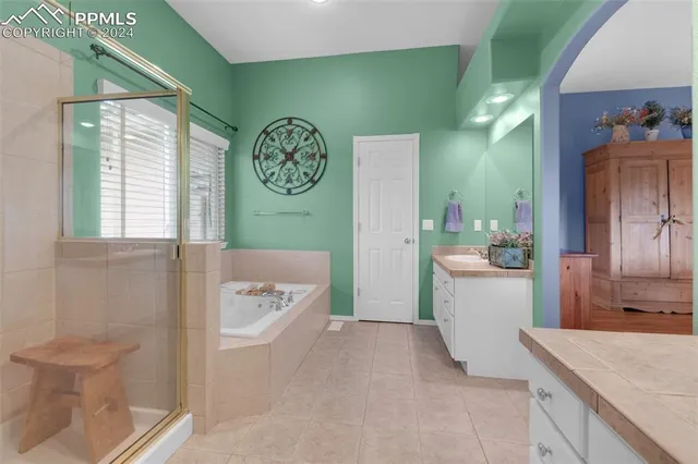 a room with a desk and book shelfs