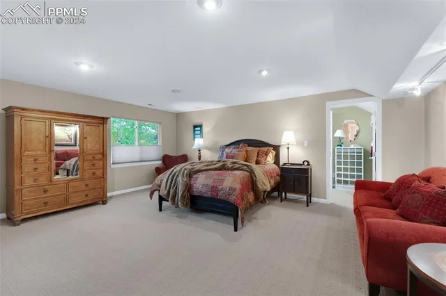 a spacious bedroom with a large bed and a couch