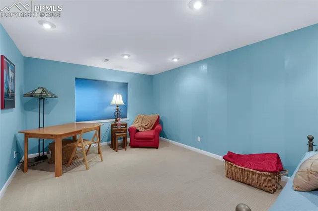 a view of a field with an trees in the background