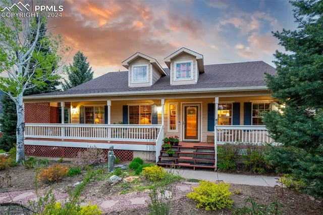 a view of house with garage and yard