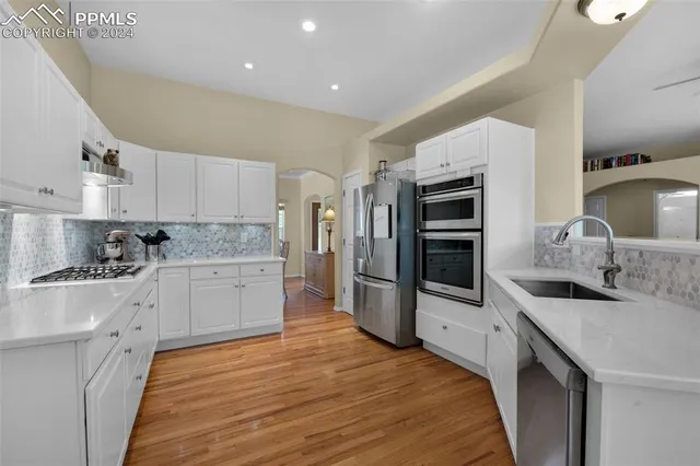 a stove top oven sitting inside of a kitchen