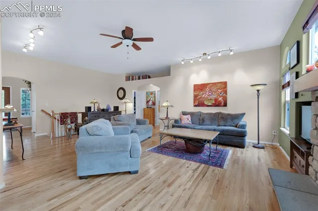 a living room with furniture and kitchen view