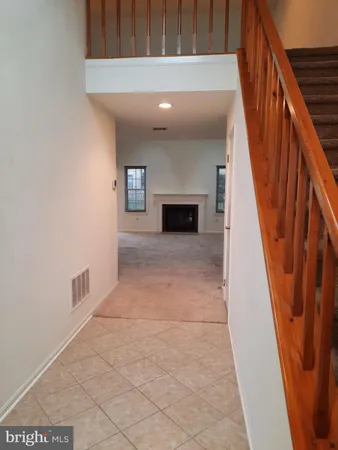 a view of empty room with a fireplace