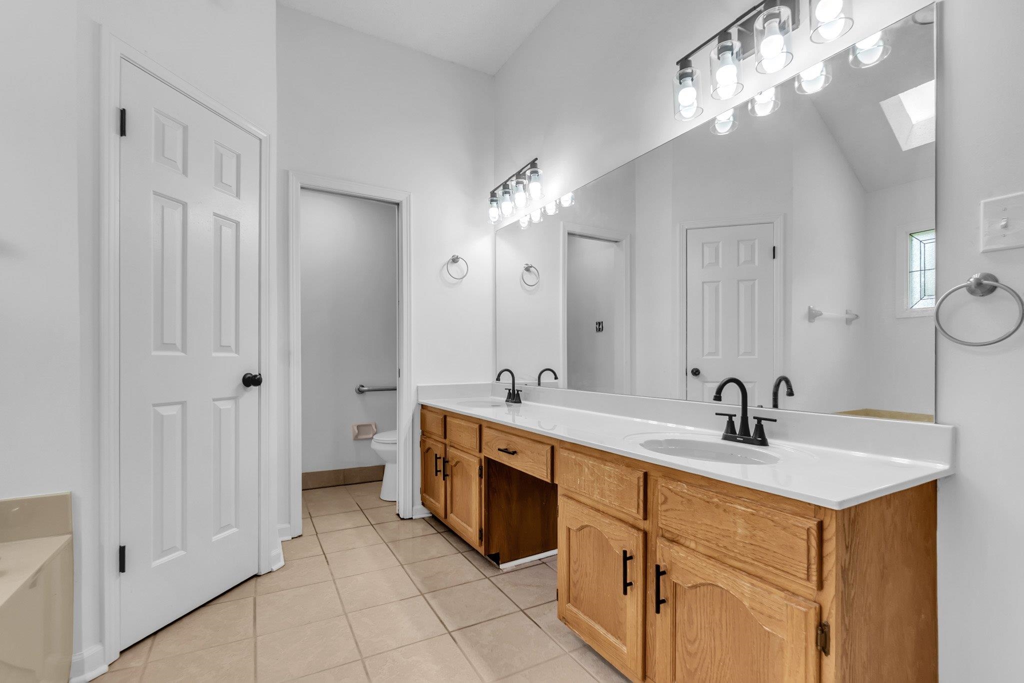6613 Stephan Ridge Drive Bartlett, TN 38135 - Photo 20 of 24 Dual vanity with light wood cabinetry and white countertops