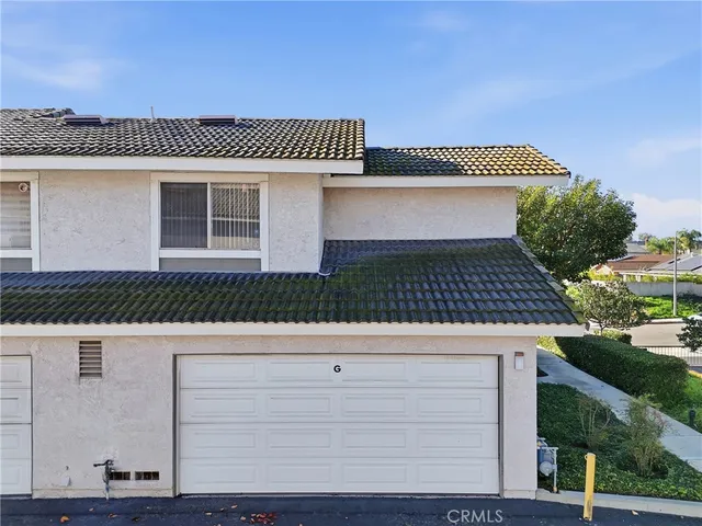 a view of a house with a wooden fence