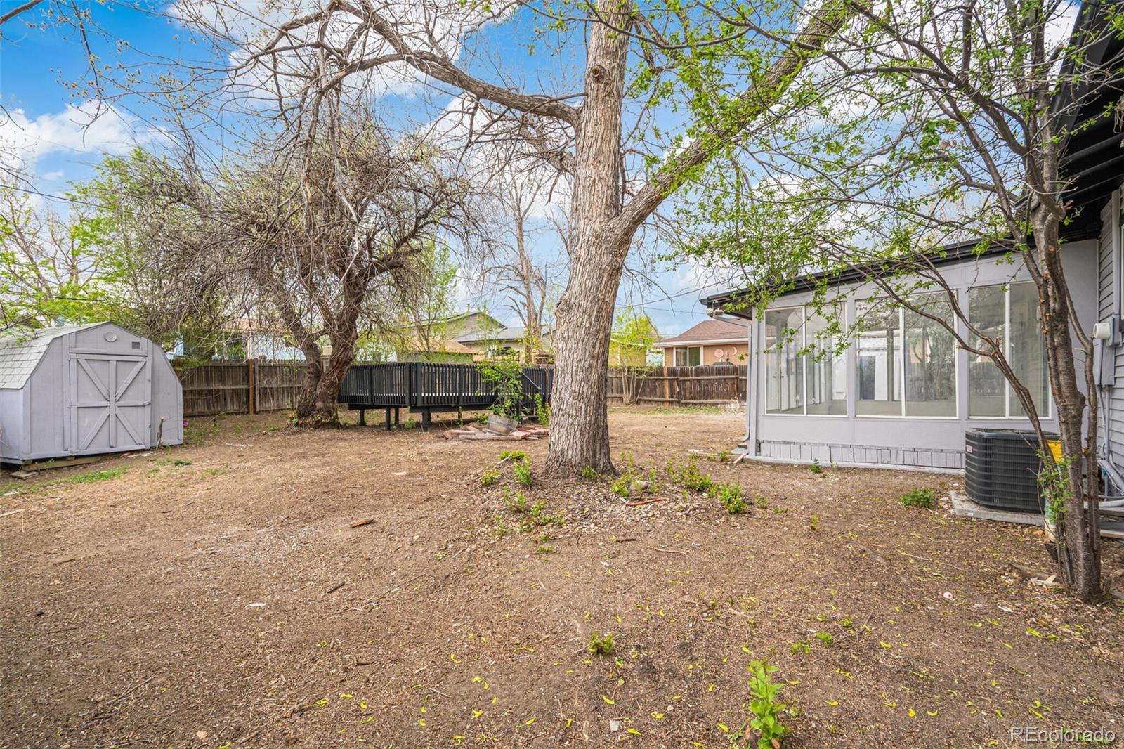 2040 Mable Avenue Denver, CO 80229 - Photo 21 of 25 a front view of a house with a yard and garage