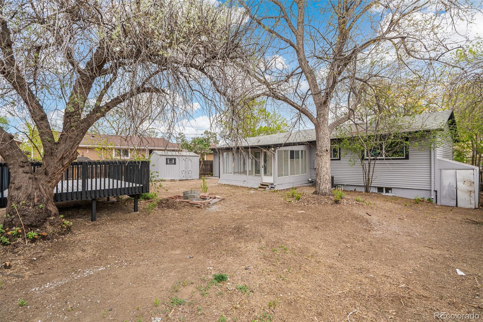 2040 Mable Avenue Denver, CO 80229 - Photo 23 of 25 a view of a house with a yard and trees
