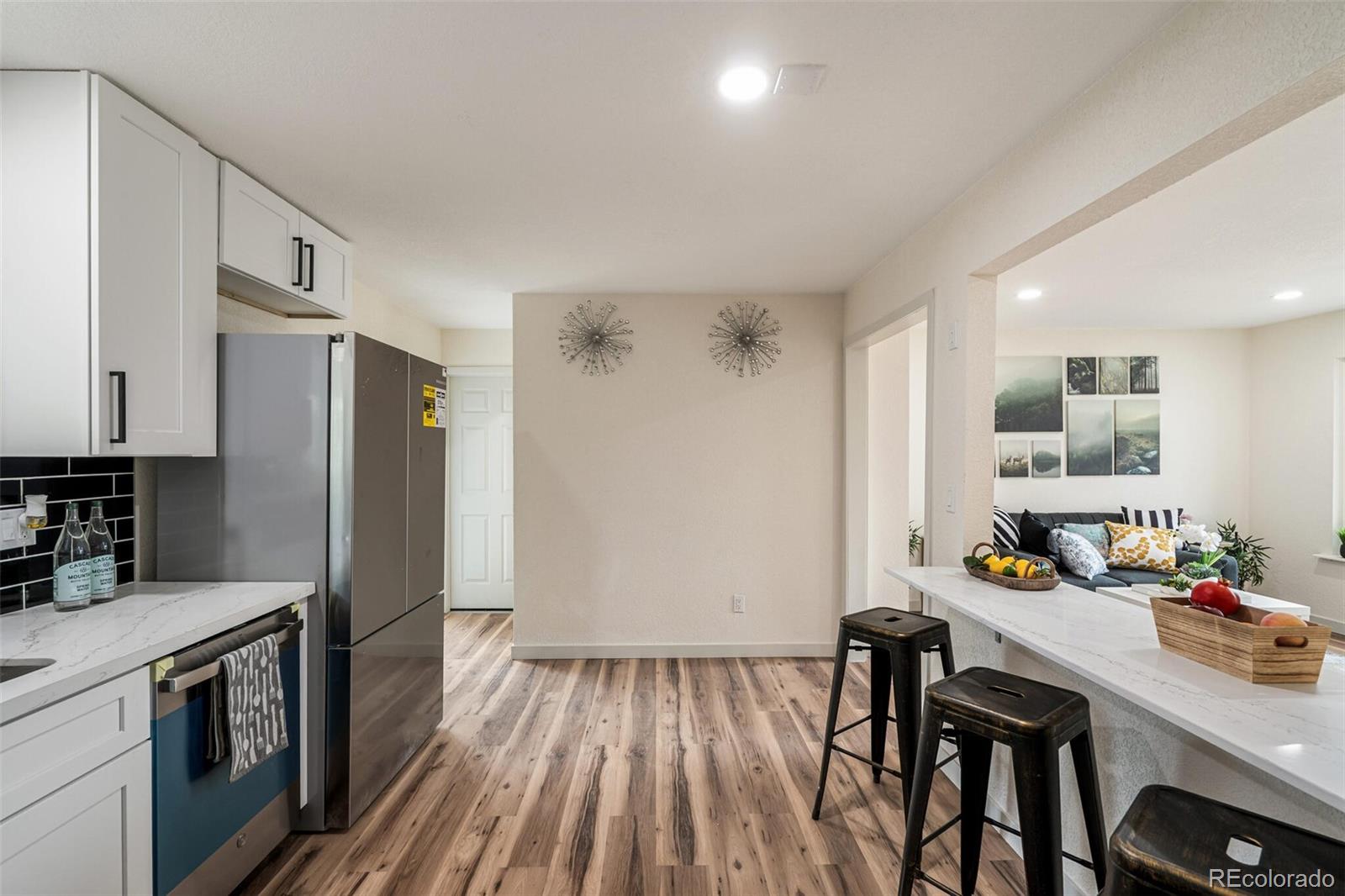2040 Mable Avenue Denver, CO 80229 - Photo 8 of 25 a kitchen with a table chairs refrigerator and cabinets