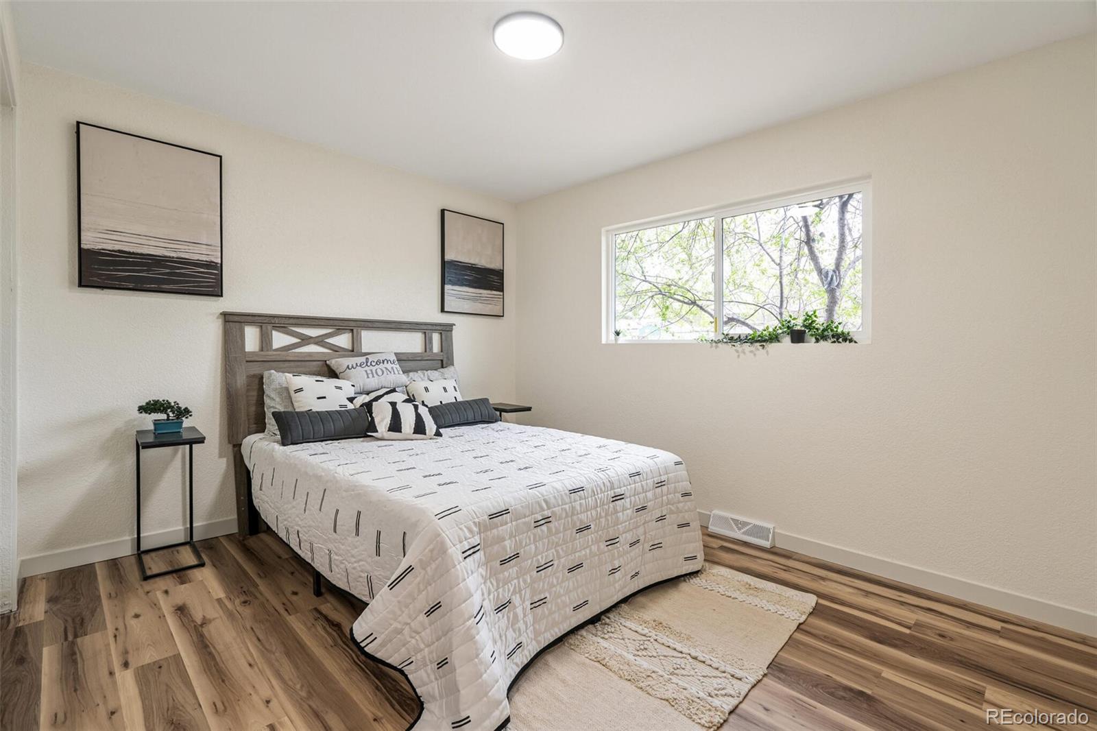 2040 Mable Avenue Denver, CO 80229 - Photo 9 of 25 a bedroom with a bed and a window