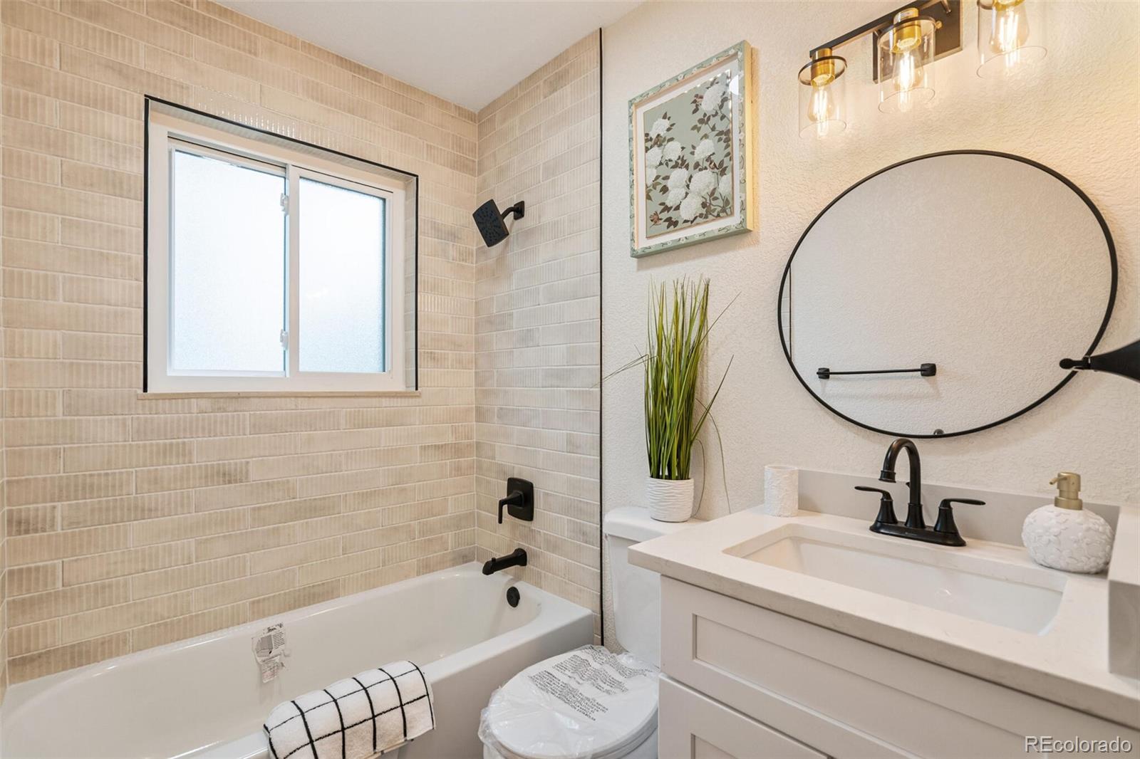 2040 Mable Avenue Denver, CO 80229 - Photo 10 of 25 a bathroom with a sink and a mirror
