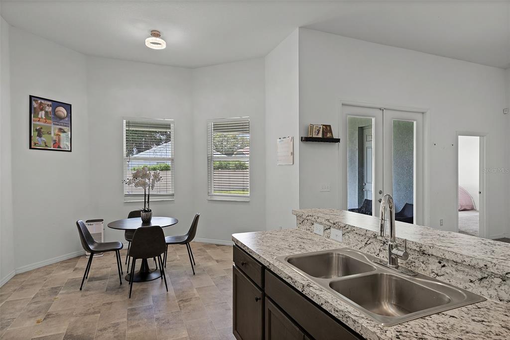 804 Channing Street Winter Haven, FL 33880 - Photo 12 of 31 a kitchen with a sink and chairs