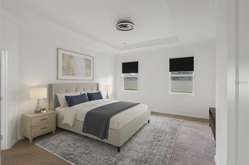 804 Channing Street Winter Haven, FL 33880 - Photo 15 of 31 a spacious bedroom with a bed and wooden floor