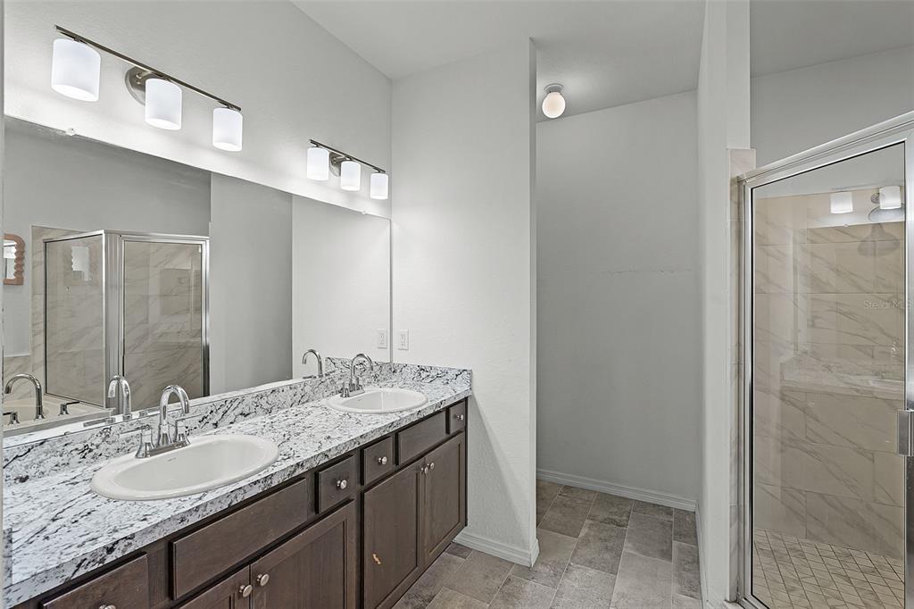 804 Channing Street Winter Haven, FL 33880 - Photo 19 of 31 a bathroom with a granite countertop sink and a mirror