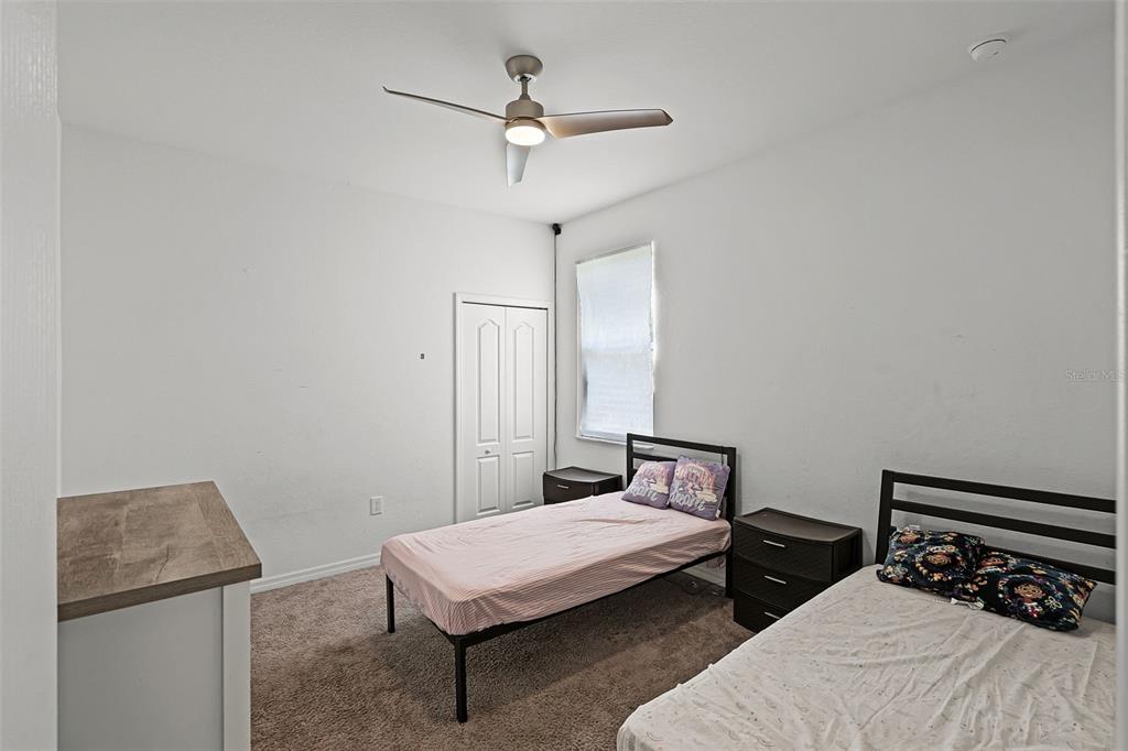 804 Channing Street Winter Haven, FL 33880 - Photo 21 of 31 a bedroom with a bed and a table