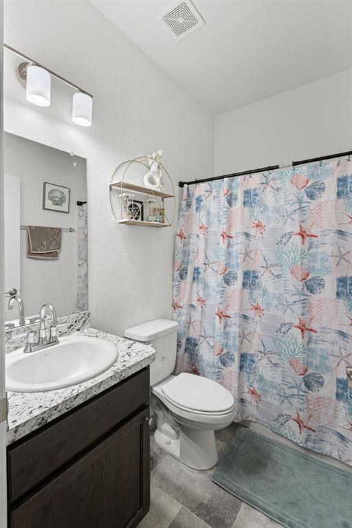 804 Channing Street Winter Haven, FL 33880 - Photo 24 of 31 a bathroom with a granite countertop sink toilet and shower