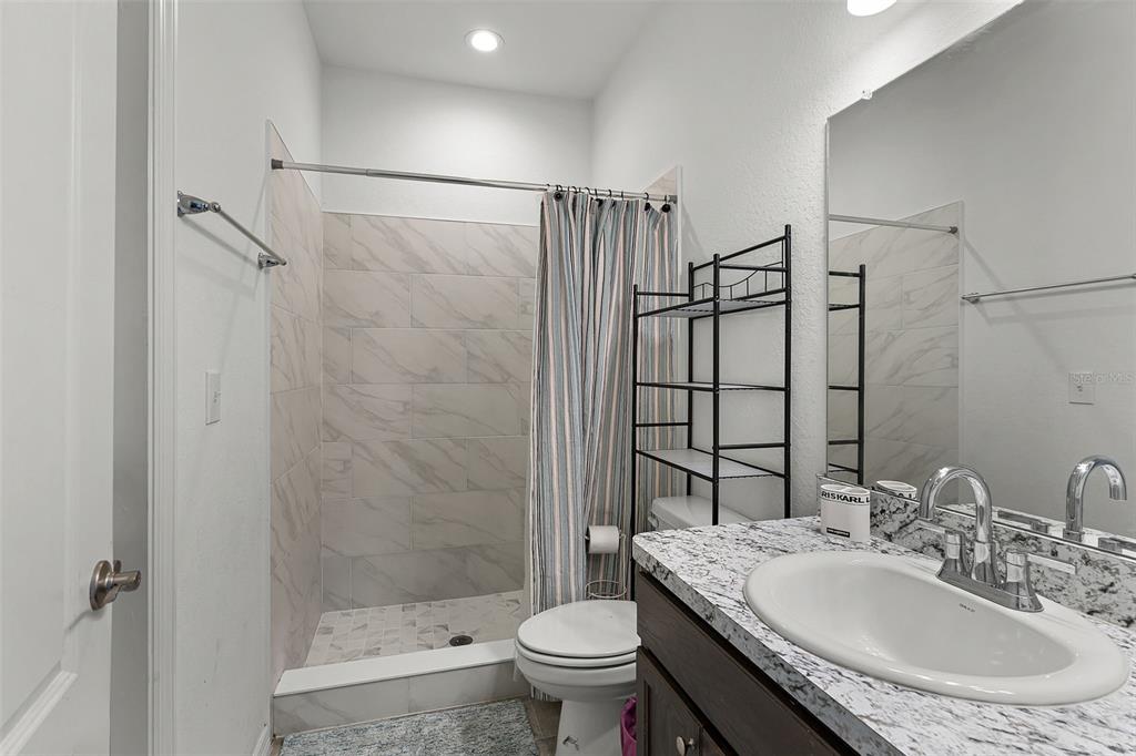 804 Channing Street Winter Haven, FL 33880 - Photo 26 of 31 a bathroom with a sink toilet and shower