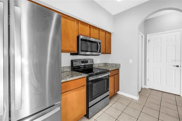 a kitchen with granite countertop a sink and a window