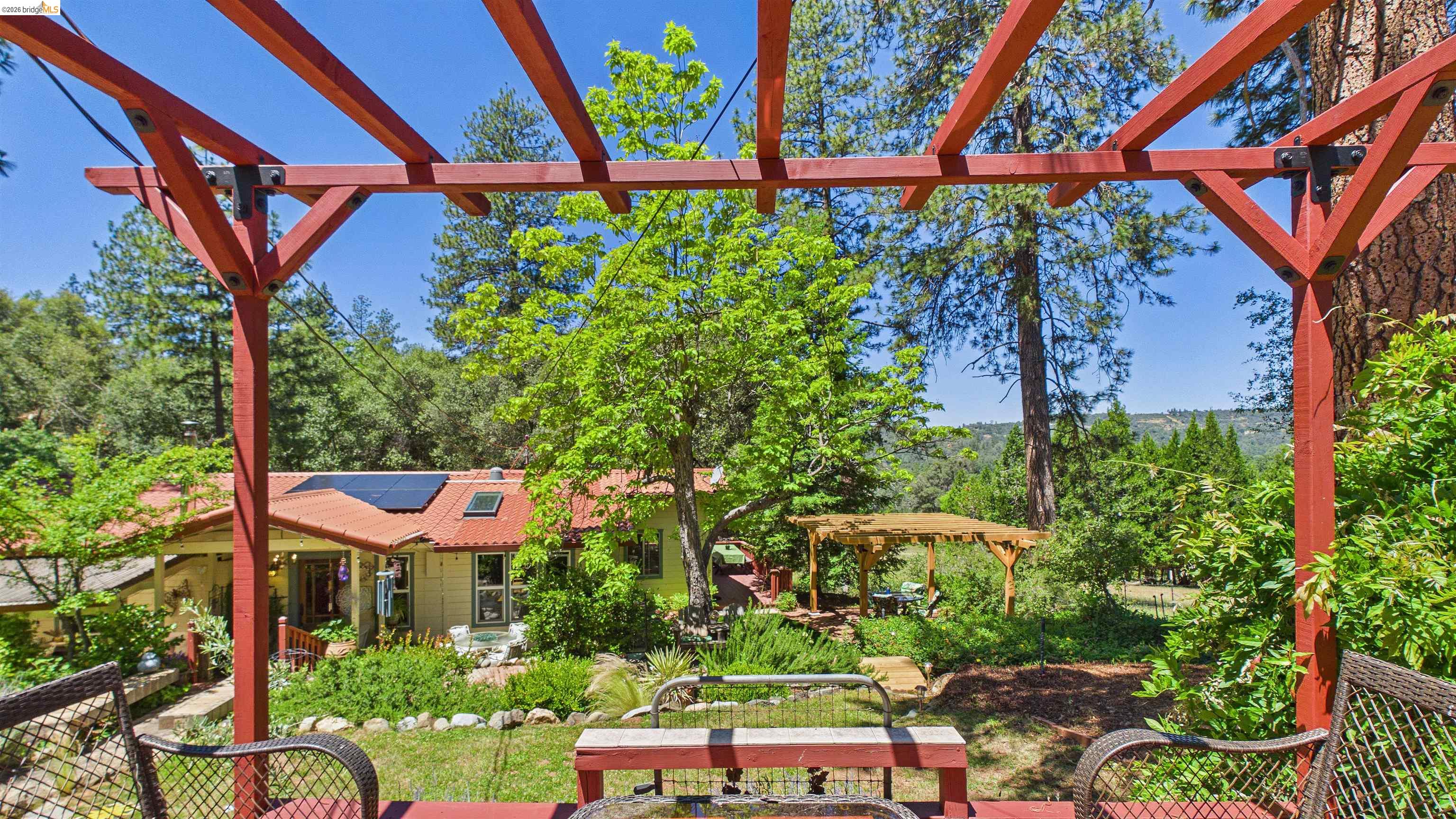 18102 Mt Eaton Road Tuolumne, CA 95379 - Photo 27 of 44 Expansive outdoor deck featuring a red wood pergola structure