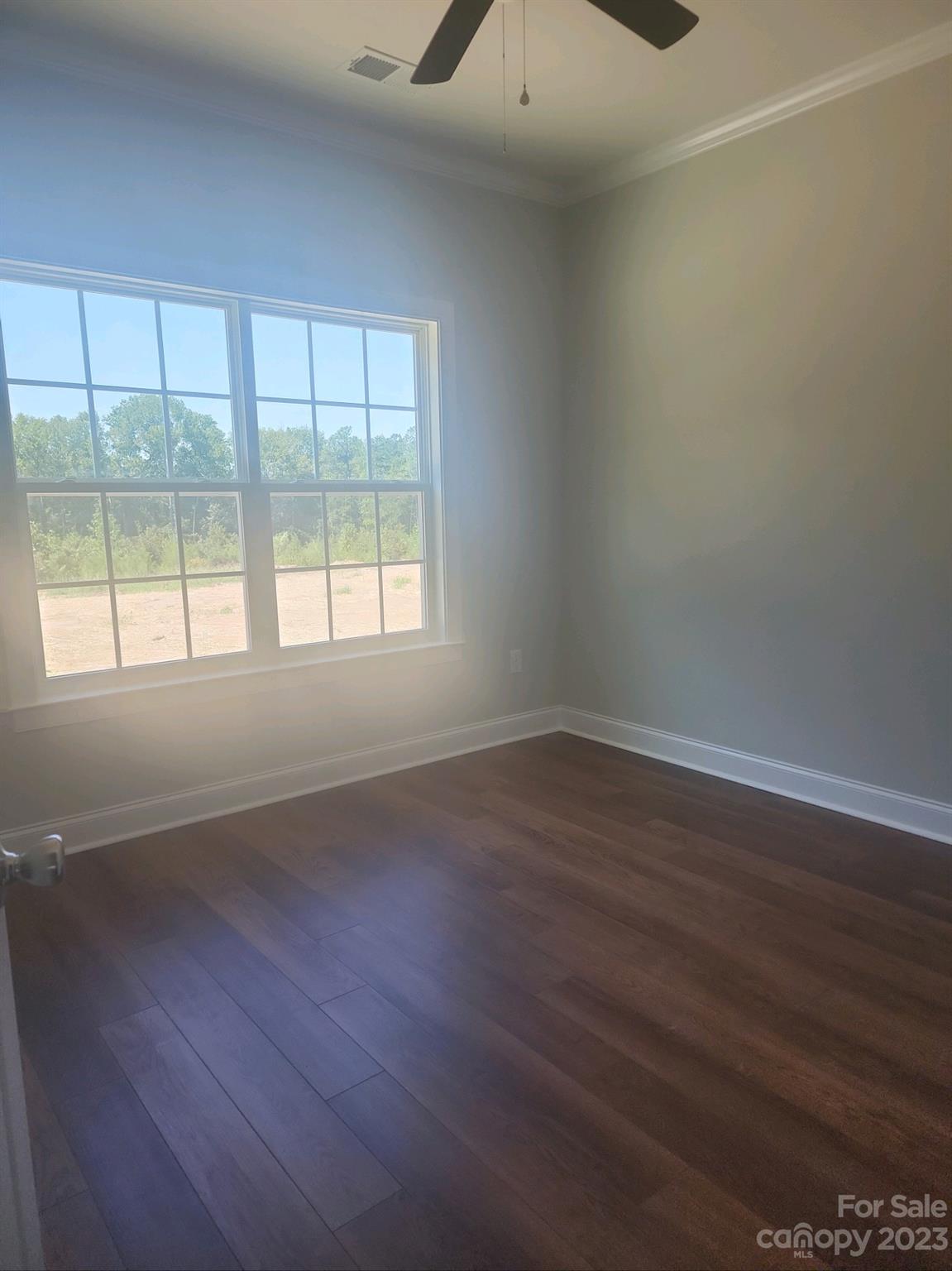 751 Crow Burk Road Pageland, SC 29728 - Photo 11 of 14 a view of an empty room with wooden floor and a window