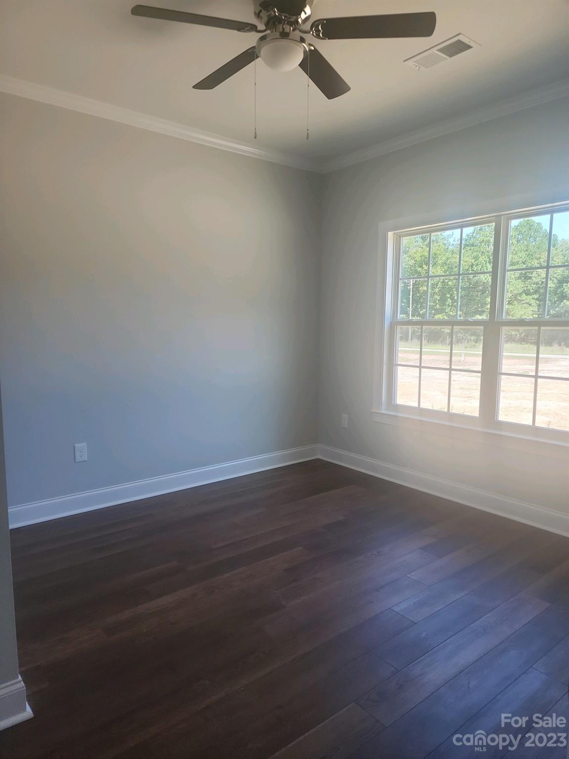 751 Crow Burk Road Pageland, SC 29728 - Photo 14 of 14 an empty room with wooden floor fan and windows