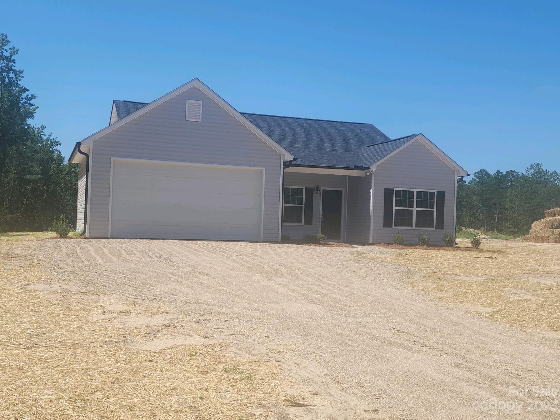 751 Crow Burk Road Pageland, SC 29728 - Photo 2 of 14 a front view of a house with a yard