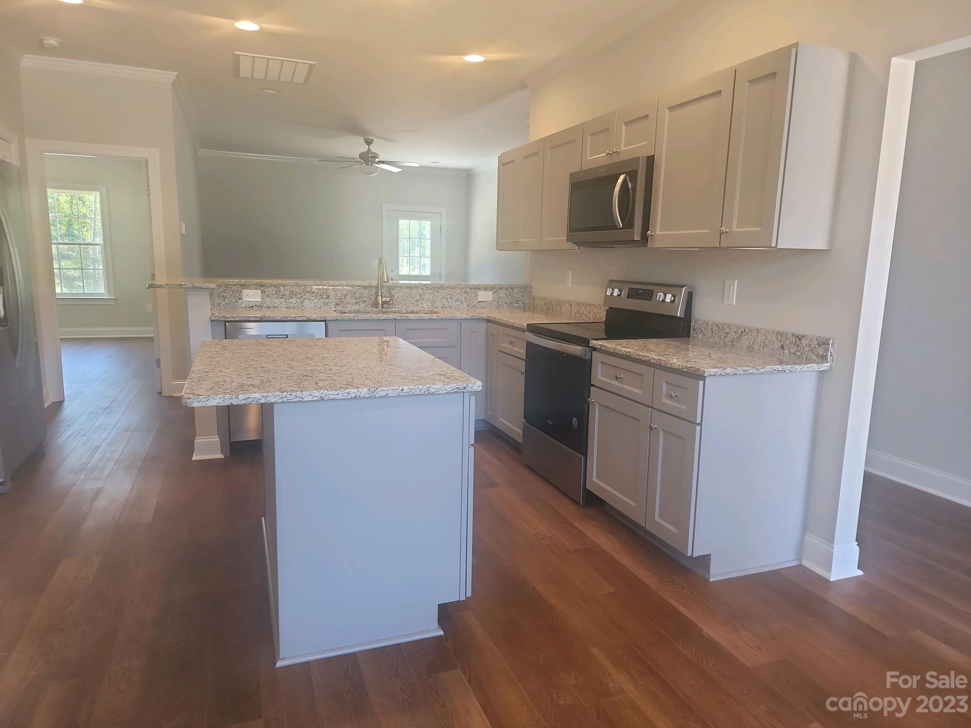 751 Crow Burk Road Pageland, SC 29728 - Photo 5 of 14 a kitchen with stainless steel appliances granite countertop a sink stove and microwave