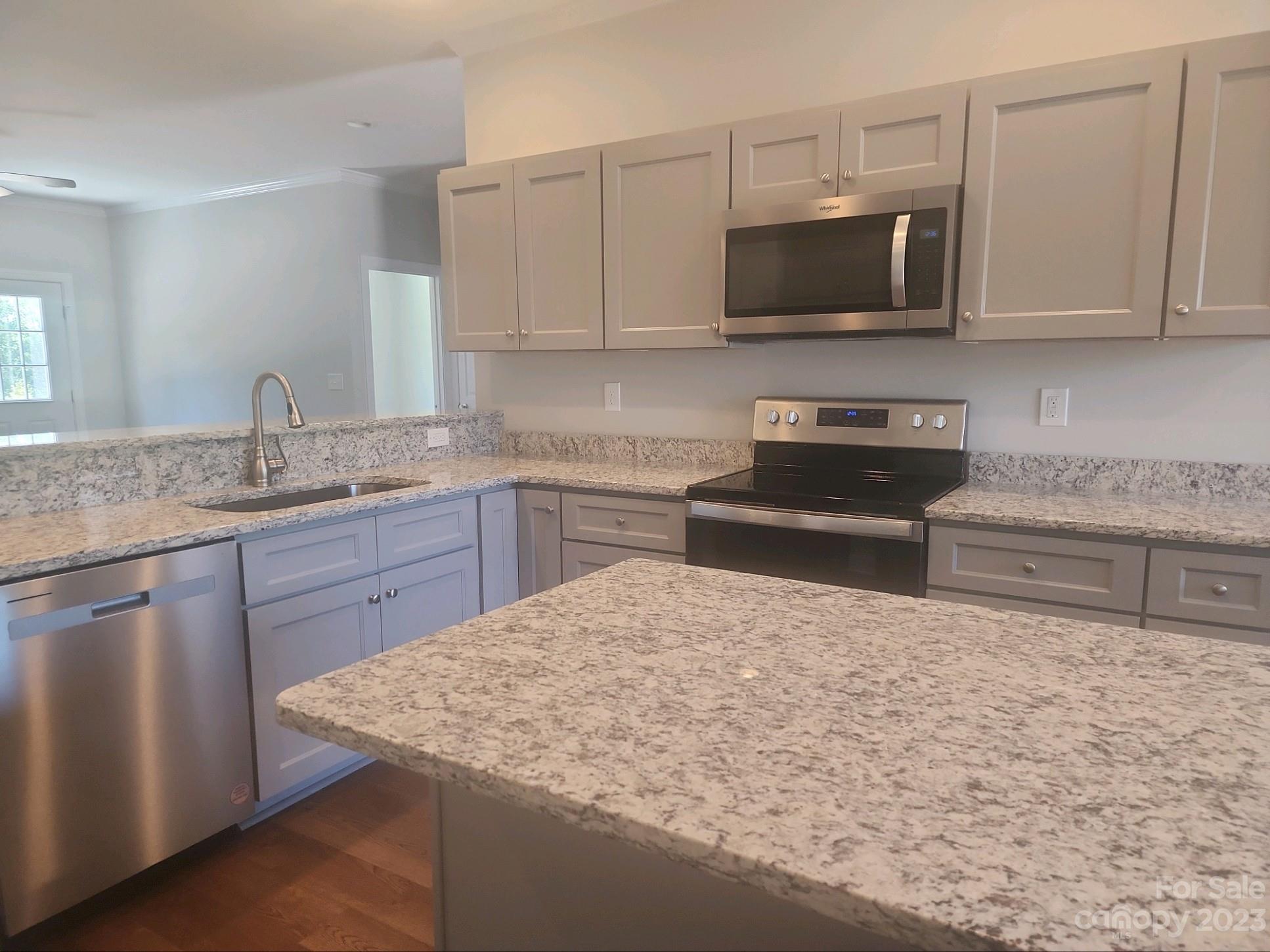 751 Crow Burk Road Pageland, SC 29728 - Photo 6 of 14 a kitchen with stainless steel appliances granite countertop a sink a stove top oven and granite counter tops
