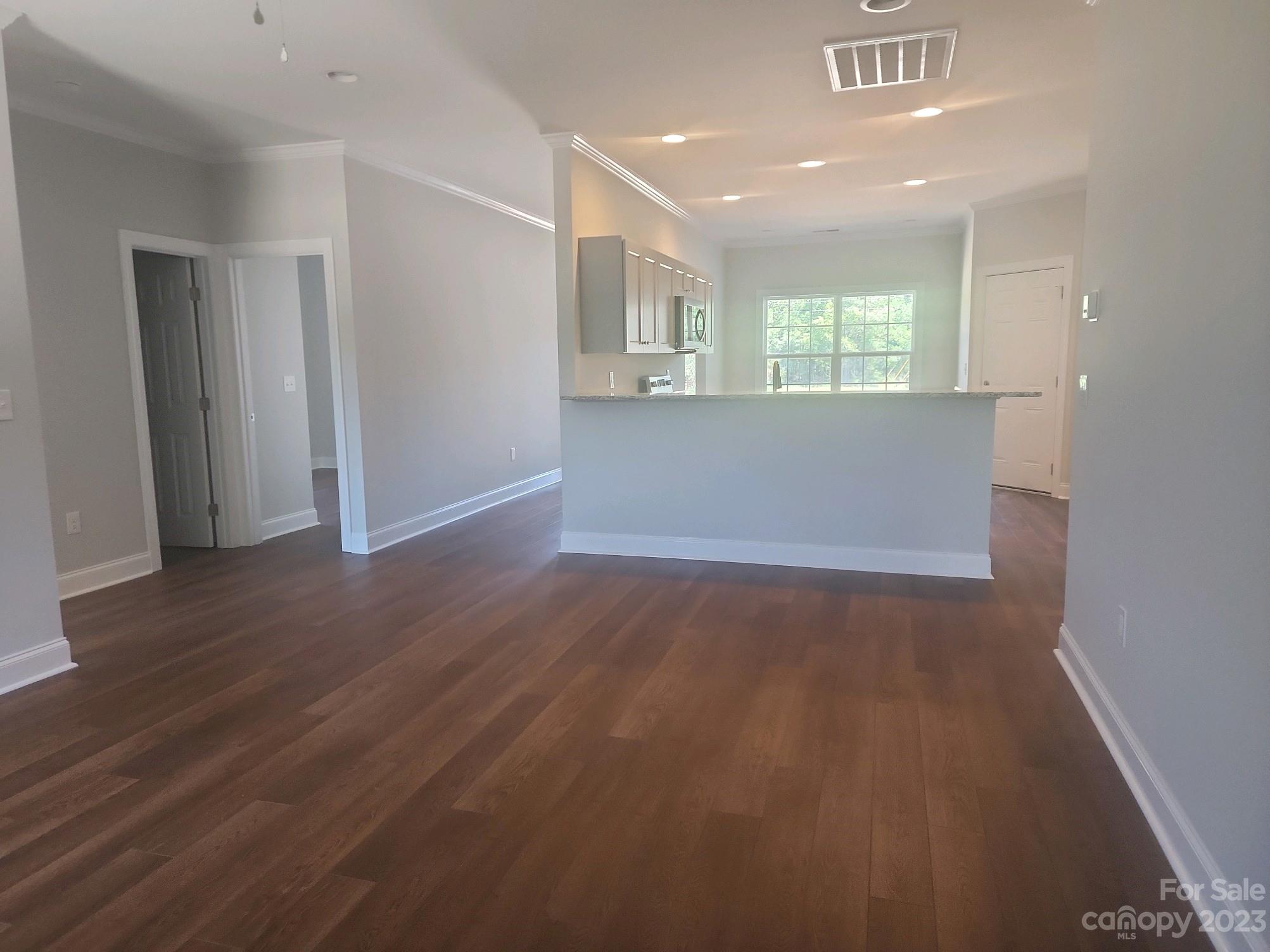 751 Crow Burk Road Pageland, SC 29728 - Photo 7 of 14 a view of an empty room with wooden floor and a window