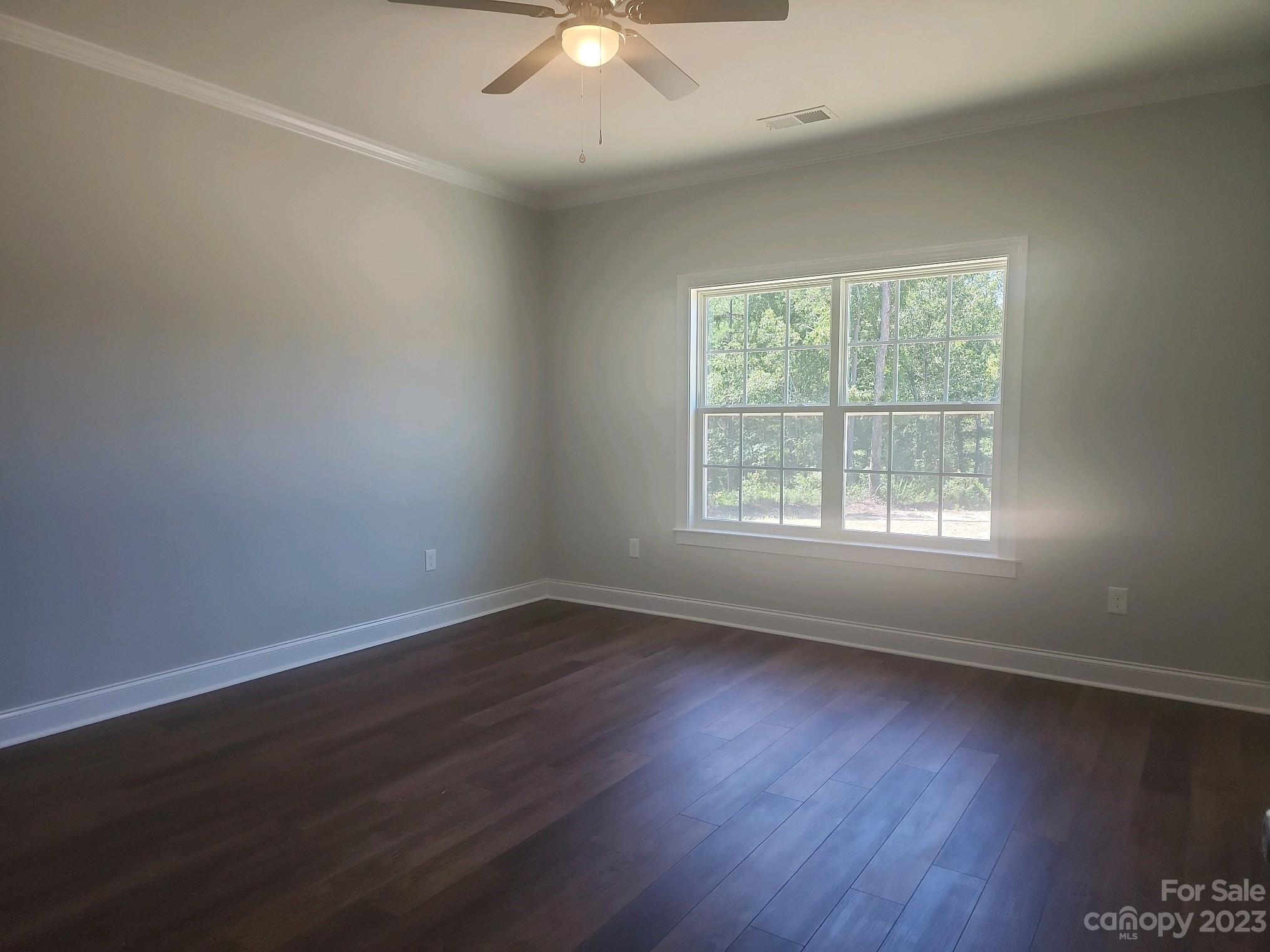 751 Crow Burk Road Pageland, SC 29728 - Photo 9 of 14 a view of an empty room with wooden floor and a window