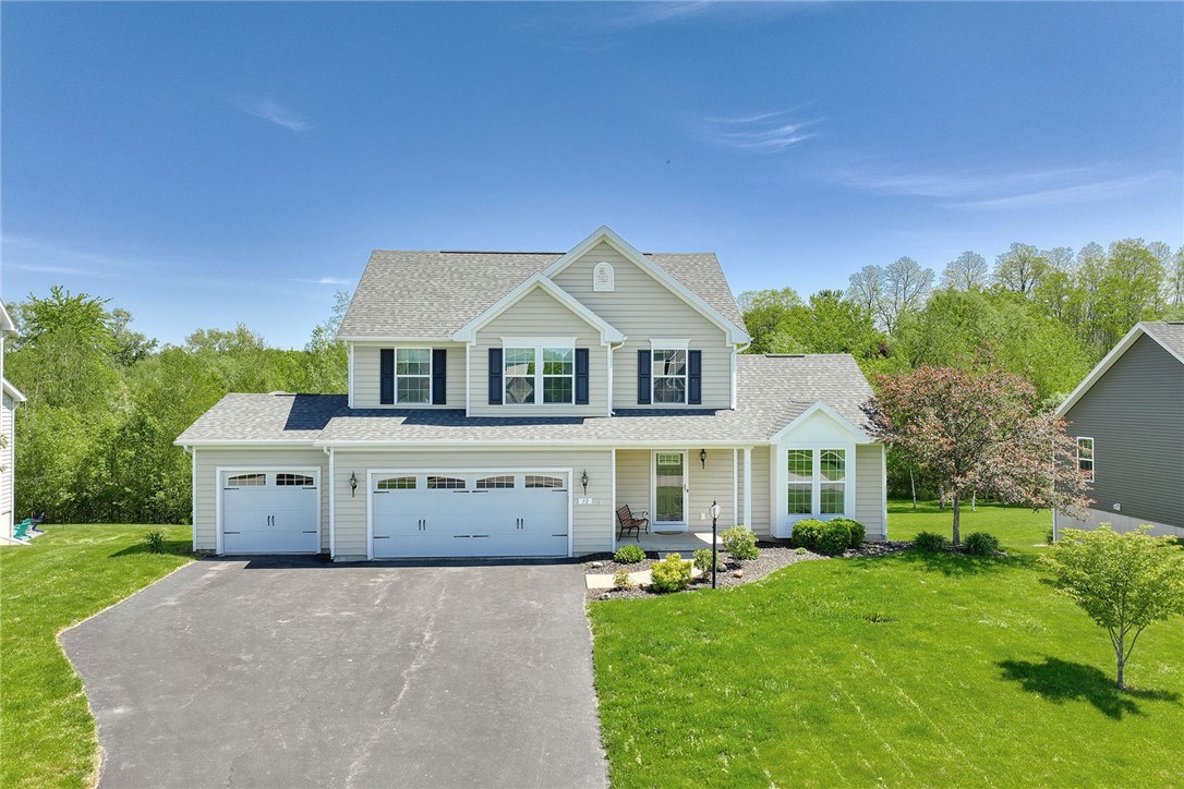 Stunning vinyl sided home with 3 car garage on Pri