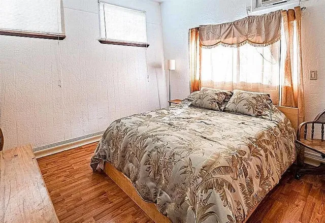 a kitchen with stainless steel appliances granite countertop a stove a sink dishwasher and a refrigerator with wooden floor