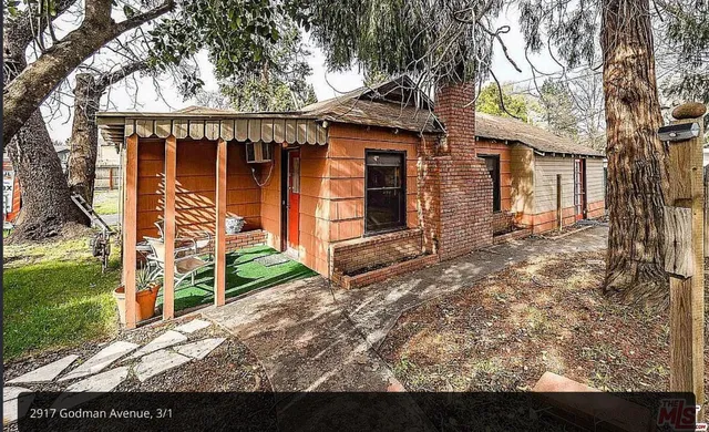 a living room with furniture and large window