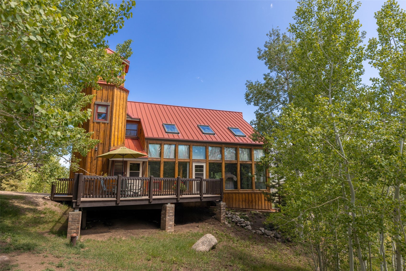 1516 Blue Ridge Road Silverthorne, CO 80498 - Photo 31 of 50 Rear view of house with a standing seam roof, a wooden deck, and a metal roof