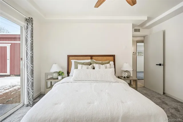 a bedroom with a bed and a large window