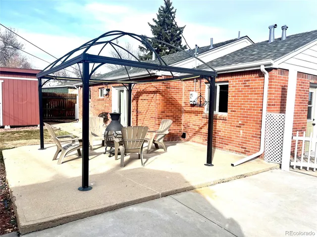 a view of a patio with a table chairs and a patio