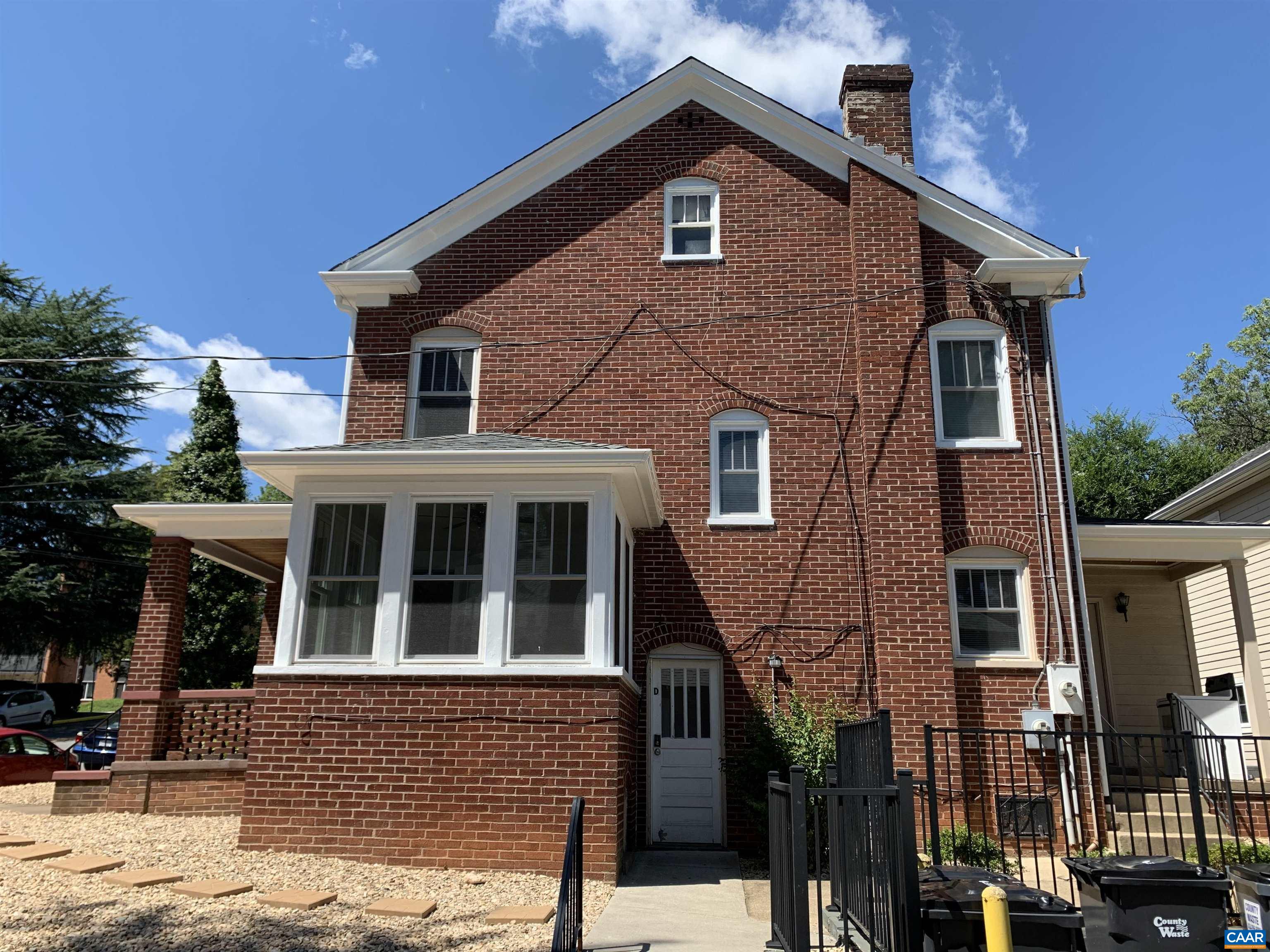1407 Grady Avenue, Unit D Charlottesville, VA 22903 - Photo 1 of 14 a front view of a house with a yard
