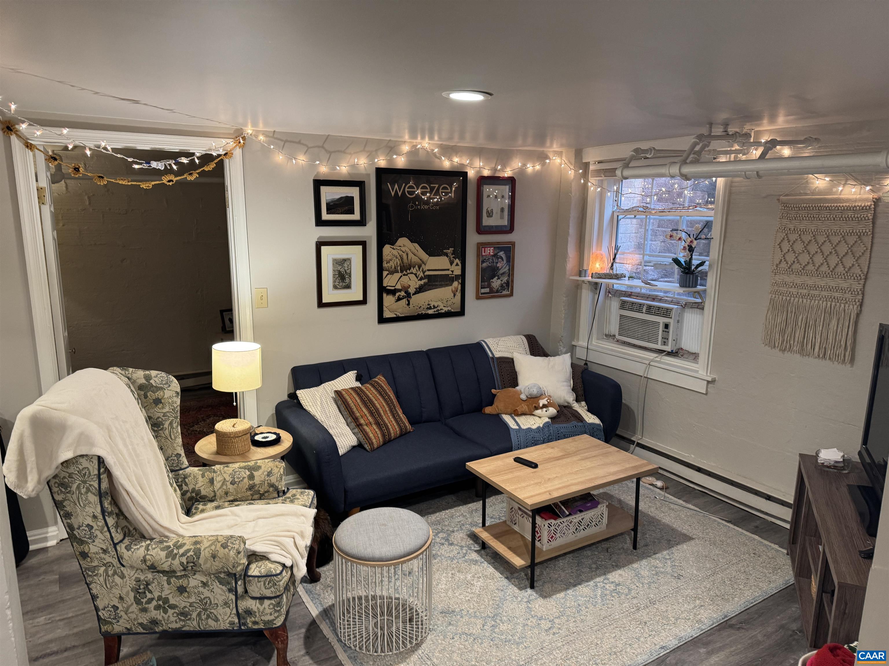 1407 Grady Avenue, Unit D Charlottesville, VA 22903 - Photo 6 of 14 a living room with furniture and a chandelier