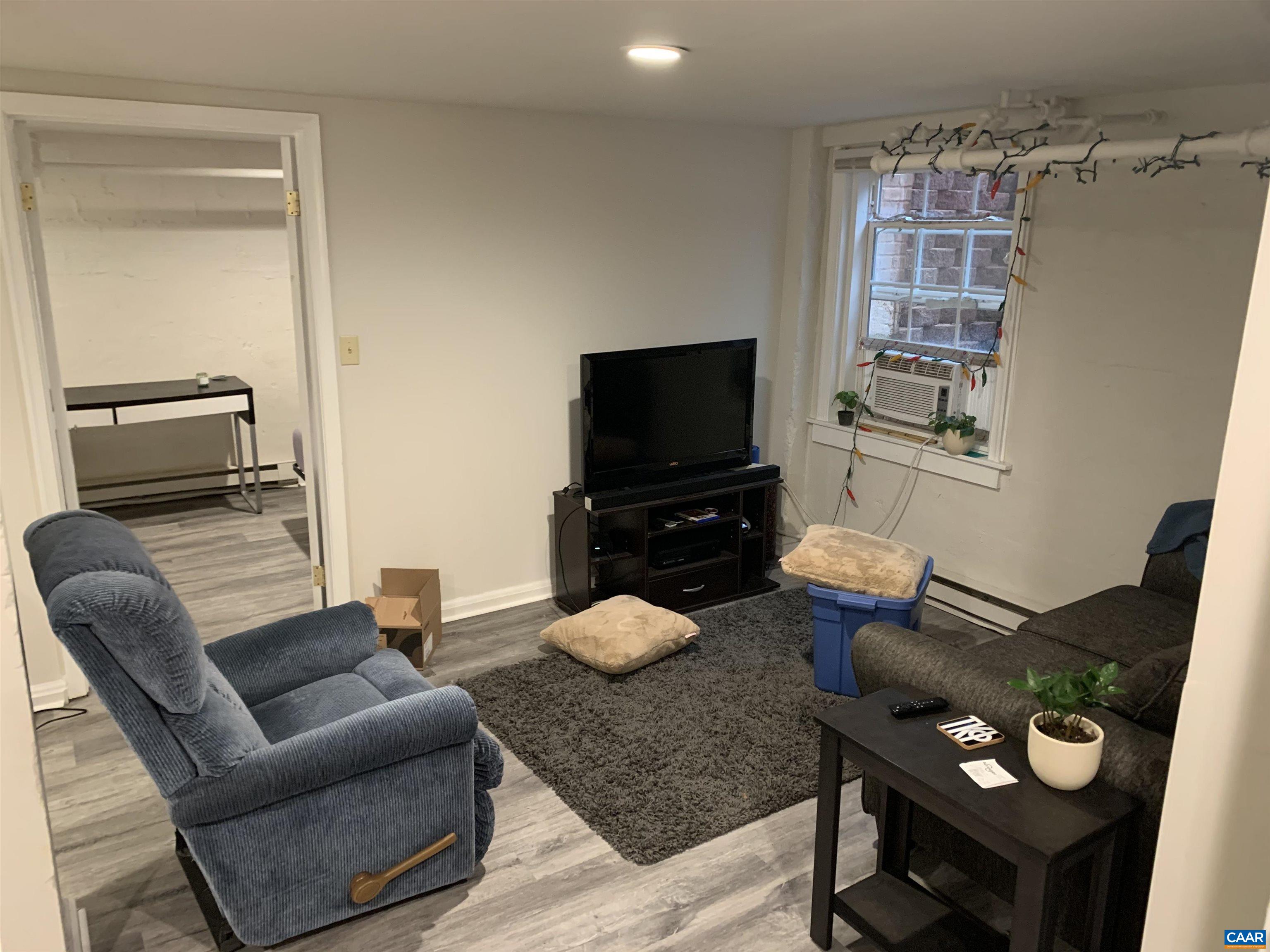 1407 Grady Avenue, Unit D Charlottesville, VA 22903 - Photo 7 of 14 a living room with furniture and a flat screen tv