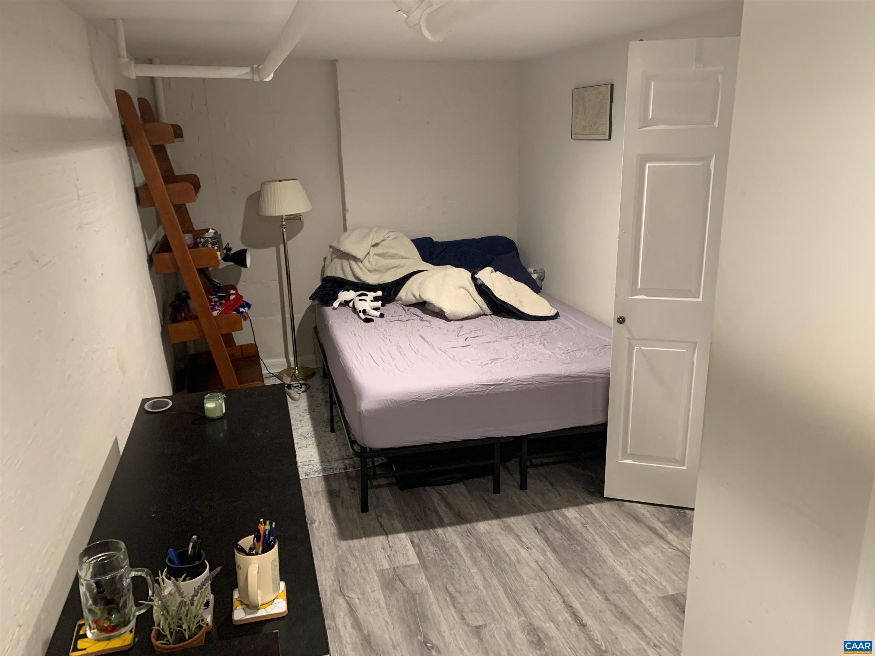 1407 Grady Avenue, Unit D Charlottesville, VA 22903 - Photo 9 of 14 a bedroom with bed and a dresser