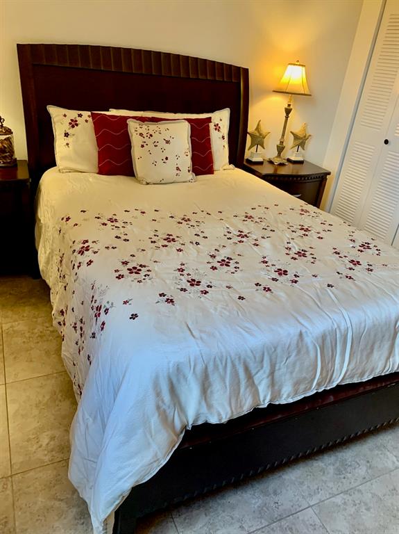 3006 Caring Way, Unit 417 Port Charlotte, FL 33952 - Photo 12 of 24 a bedroom with a bed and wooden floor