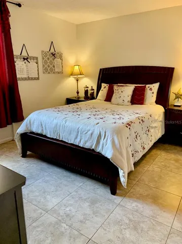 a bedroom with a bed and dresser