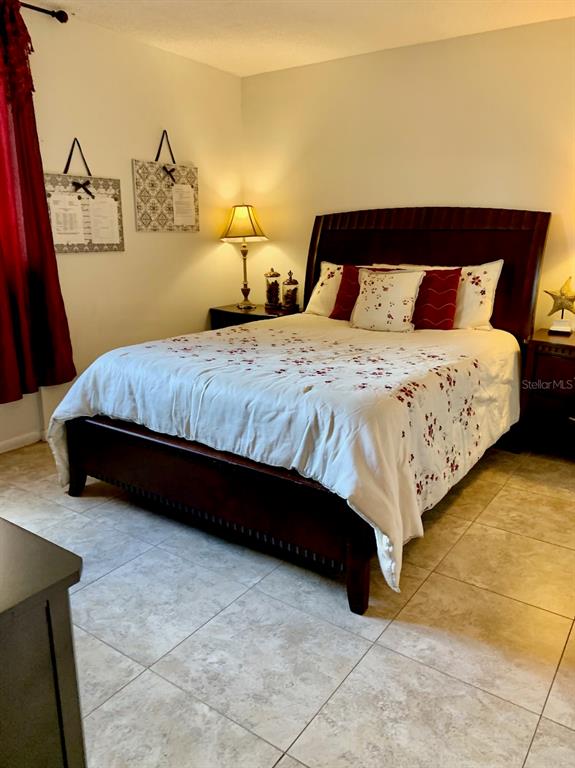 3006 Caring Way, Unit 417 Port Charlotte, FL 33952 - Photo 13 of 24 a bedroom with a bed and dresser