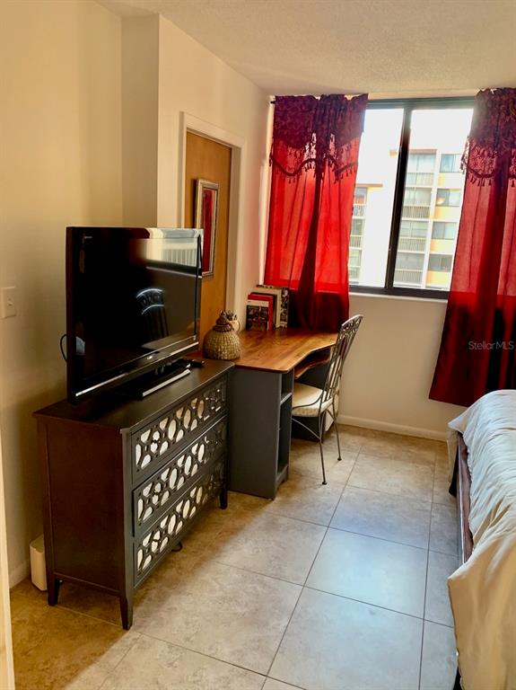 3006 Caring Way, Unit 417 Port Charlotte, FL 33952 - Photo 15 of 24 a room with furniture and a flat screen tv